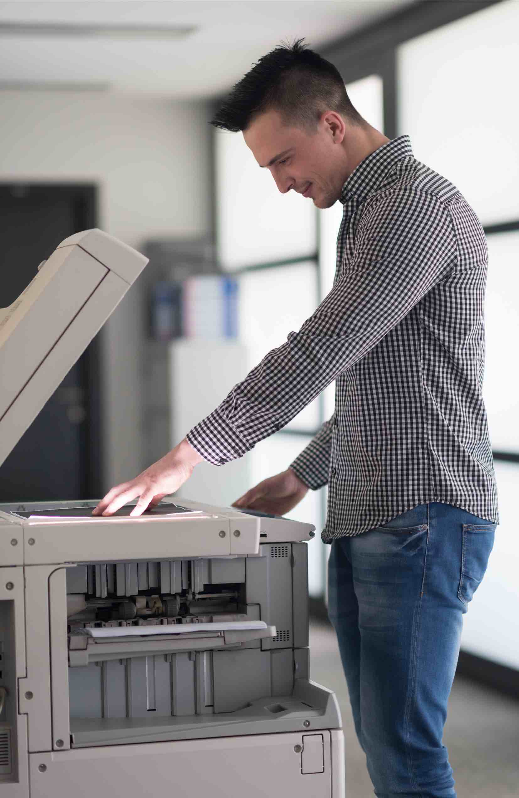 This man scans documents to get his small business go paperless thanks to tips from Paramount Tax & Accounting CPAs Provo.